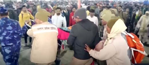 Injured devotees being transported to ambulances after the deadly 2025 Maha Kumbh stampede, with emergency responders rushing to assist the wounded.