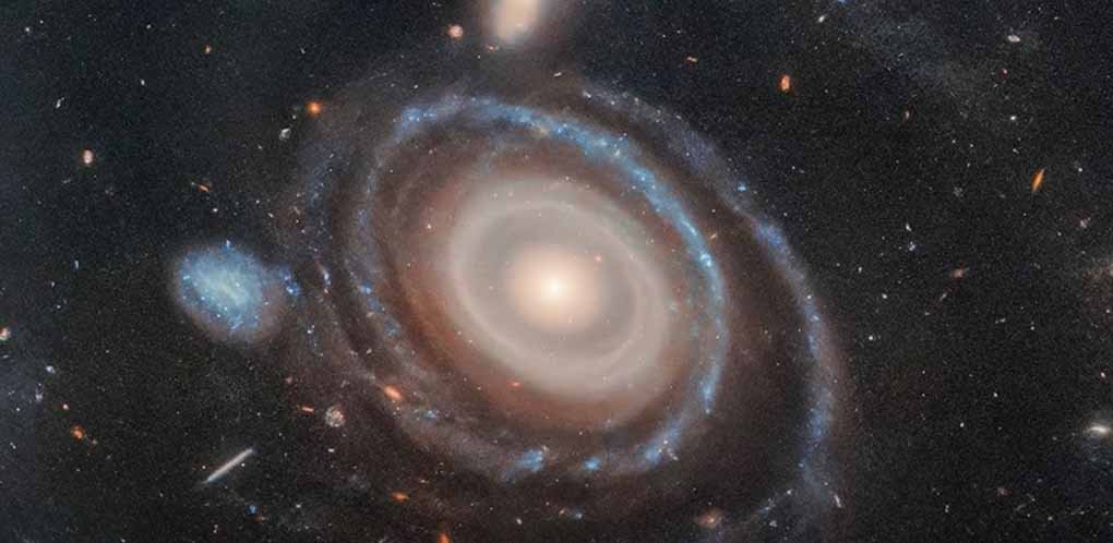 Hubble Space Telescope captures a stunning nine-ring galaxy, revealing a cosmic mystery in deep space.