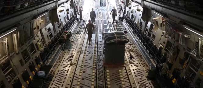 Workers load humanitarian aid supplies onto trucks for global disaster relief and emergency assistance.