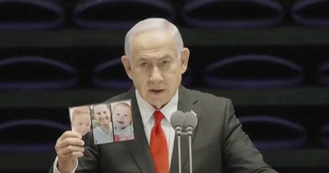 Prime Minister Netanyahu delivers a speech while showing photos of the Bibas family during a national address.