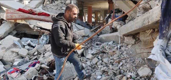 Palestinian man using his bare hands to remove rubble in Gaza, symbolizing the struggle for survival and the need for urgent reconstruction after the conflict.