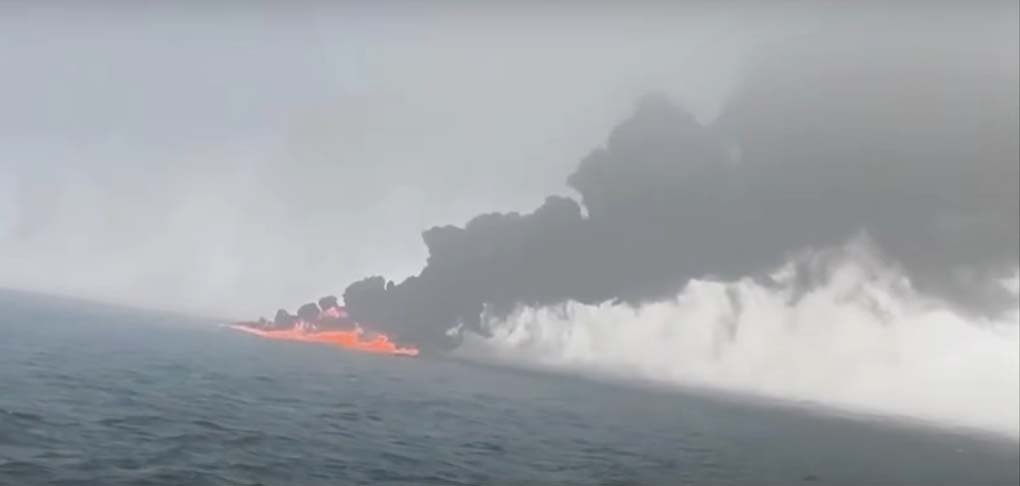 Oil tanker and cargo ship collision at sea causing major spill and shipping disruption.